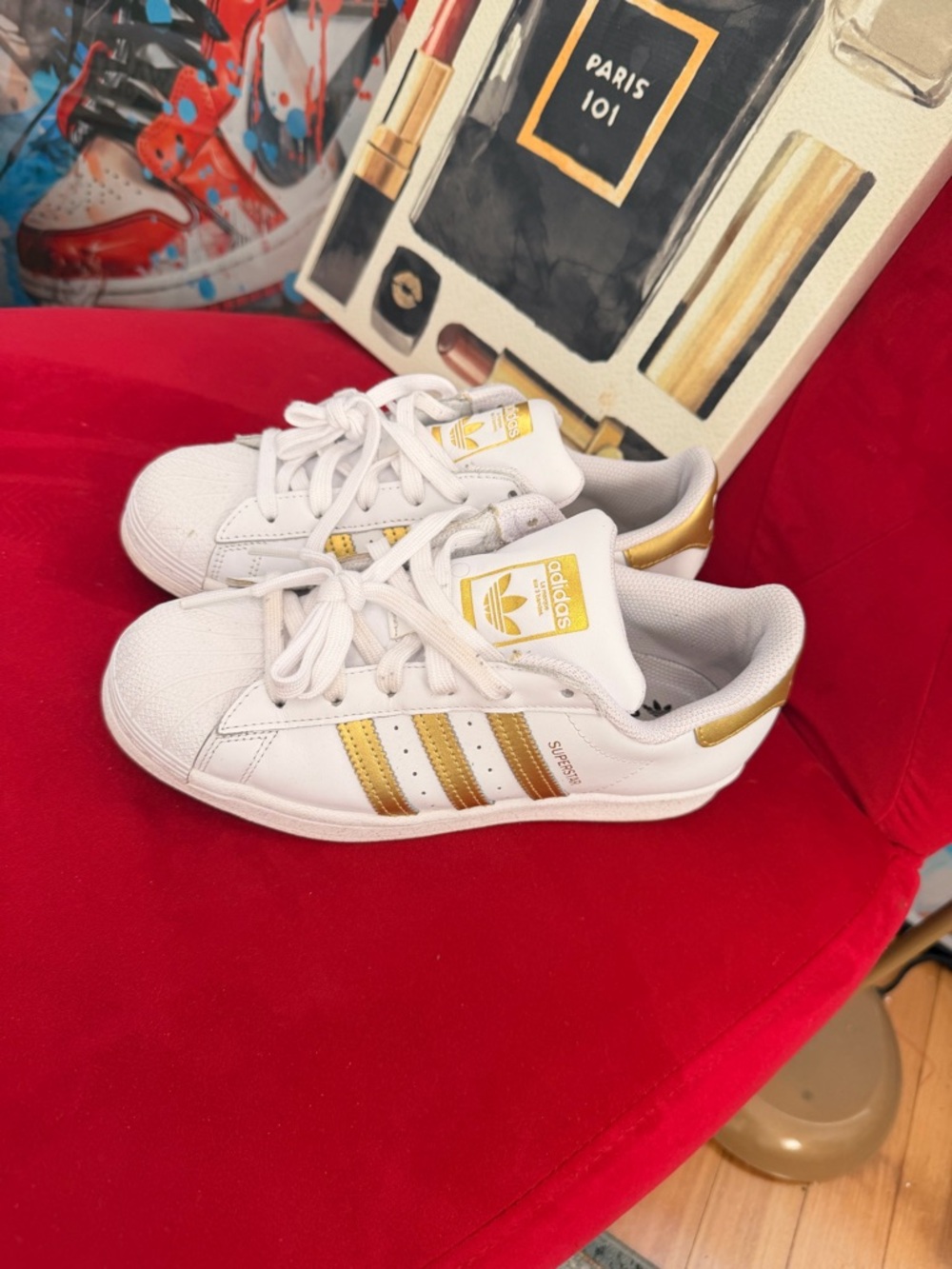adidas Women’s Shell Toe White and Gold Superstar Sneakers